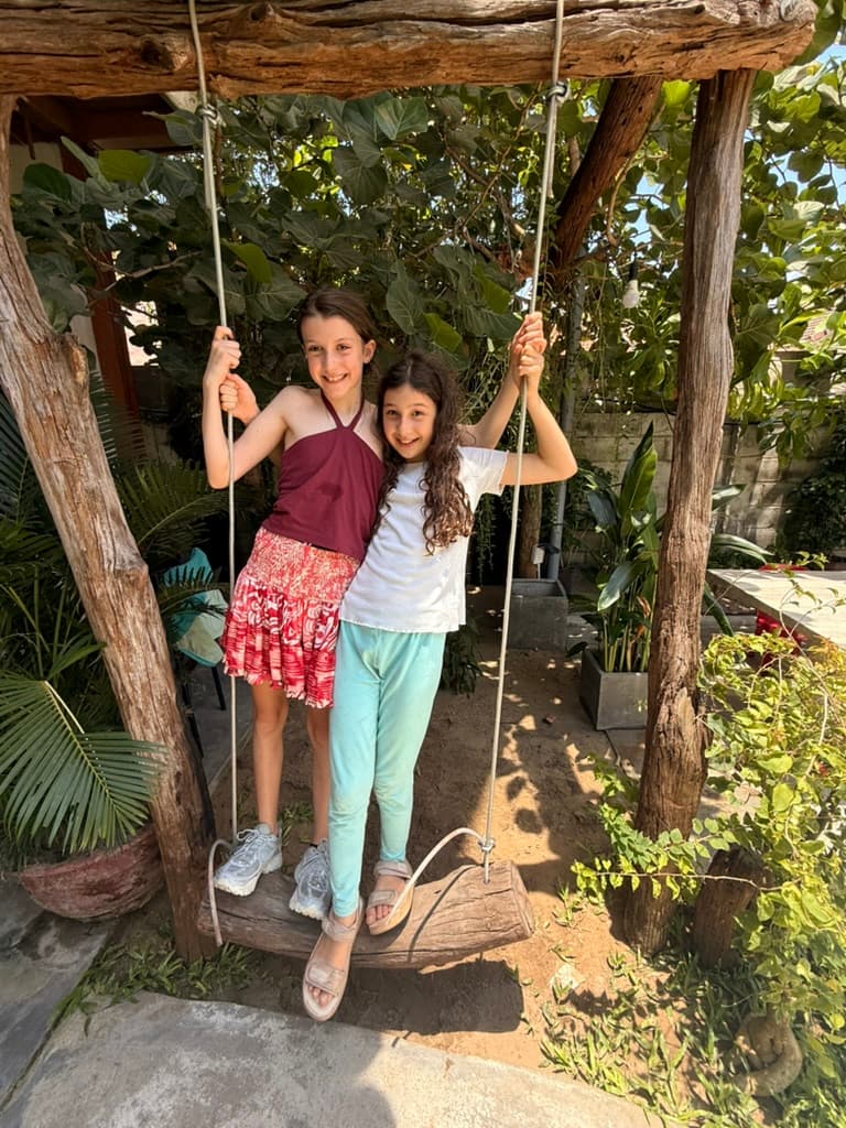 New friends playing together on a swing