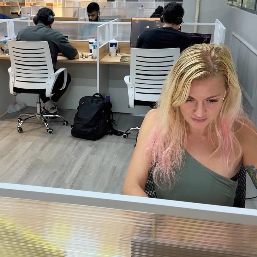 Members working at desks in the Network School coworking space