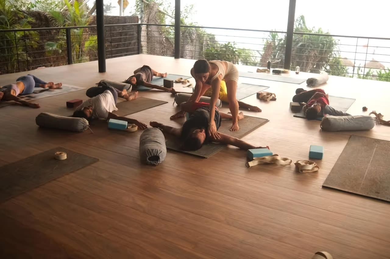 An open-air yoga class on a deck in Goa