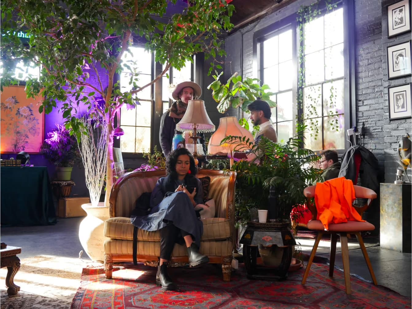 Villagers working and talking together in a relaxed shared lounge space