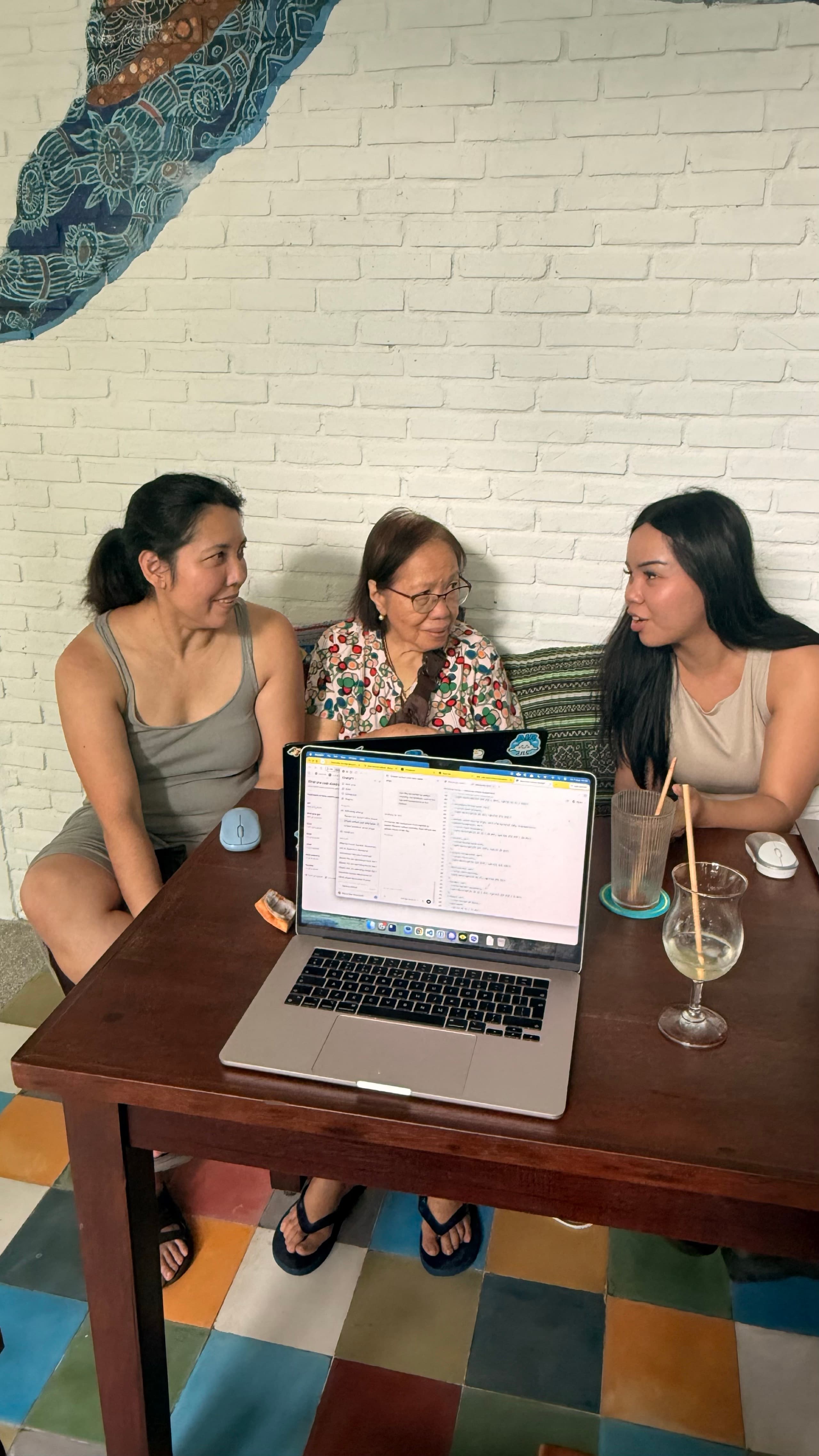 Three generations at one table, learning AI together on a laptop