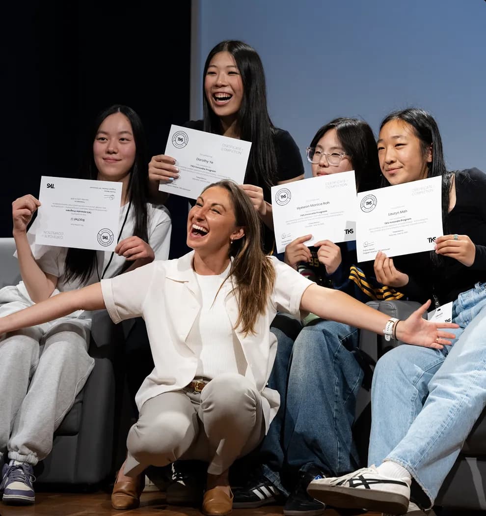 TKS students holding their completion certificates on stage