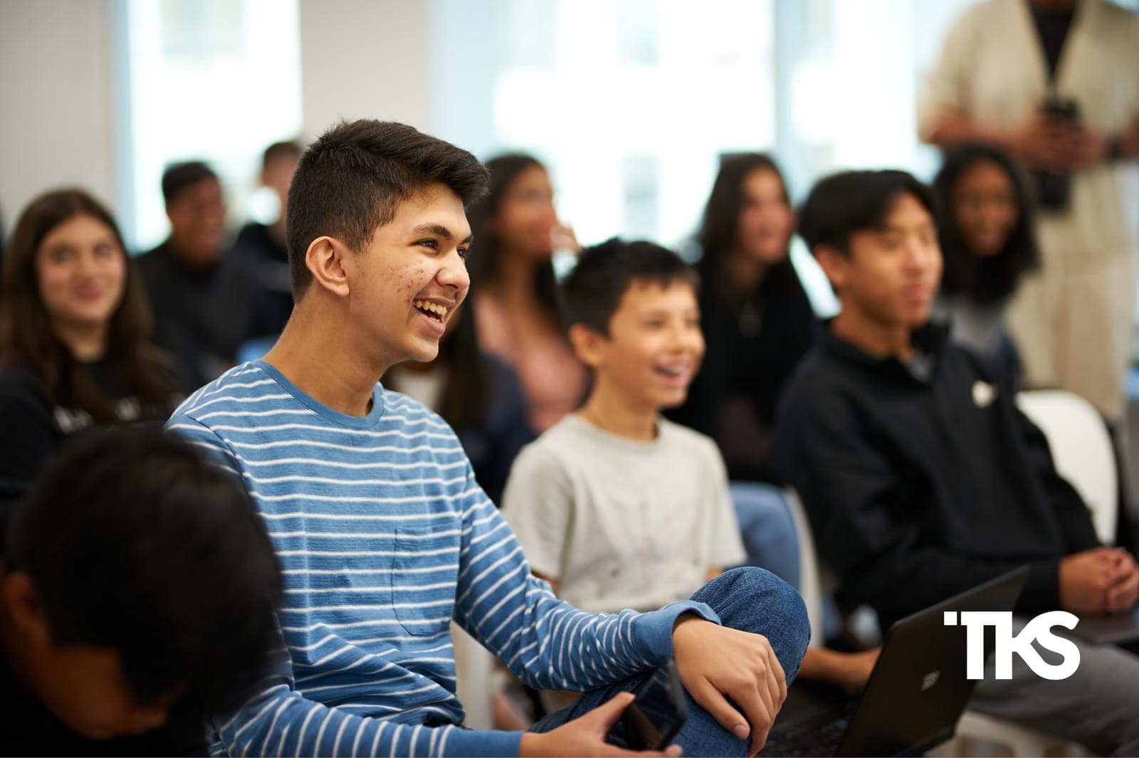 Teens laughing together during a TKS hub session